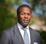 A professional headshot of a man.