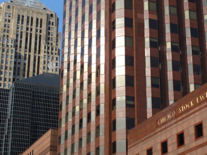 Tall buildings, including the Chicago Stock Exchange in the foreground and the Board of Trade in background.